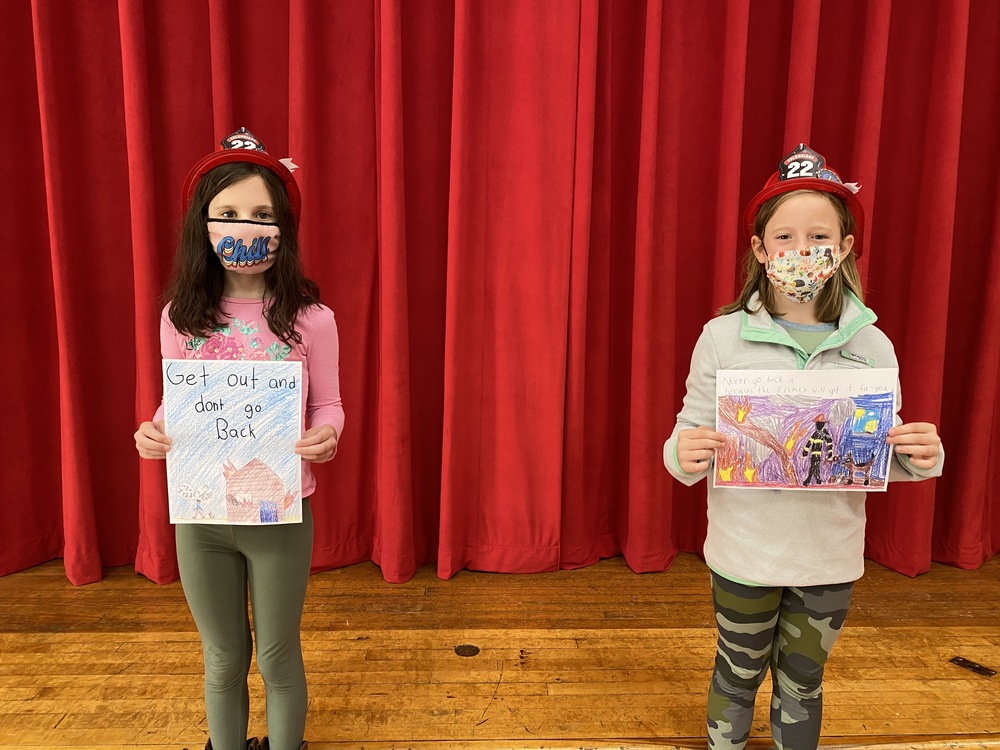 Students with their fire safety poster contest artwork
